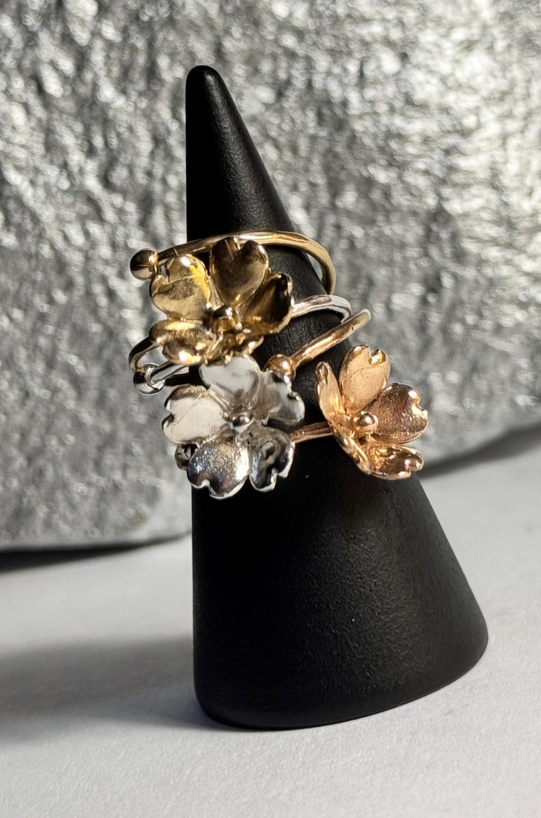 Trio di anelli a fiore di Non ti scordar di me in bronzo, argento e bronzo rosa